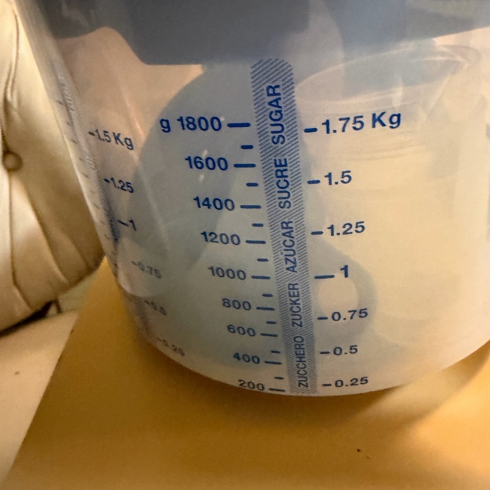 Tupperware Mix N Store Plastic measuring cup, and small yellow colander.